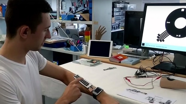 iSkin co-developer Martin Weigel shows off a rolled up keyboard for an smartwatch.